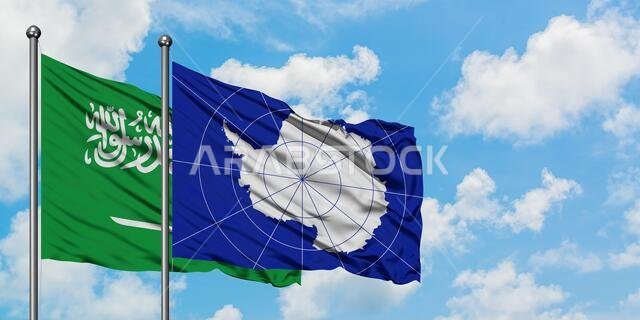 Saudi Arabia and Antarctica flag waving in the wind against white cloudy blue sky together. Diplomacy concept, international relations.