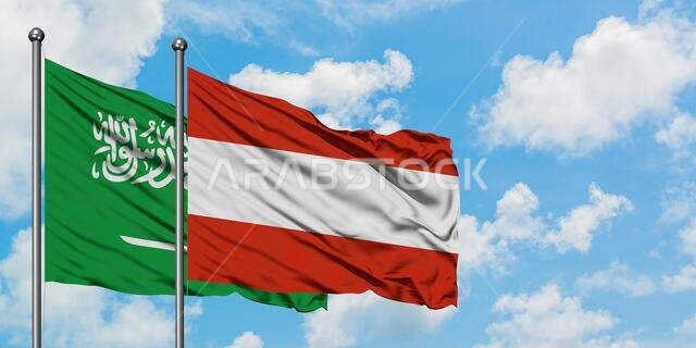 Saudi Arabia and Austria flag waving in the wind against white cloudy blue sky together. Diplomacy concept, international relations.