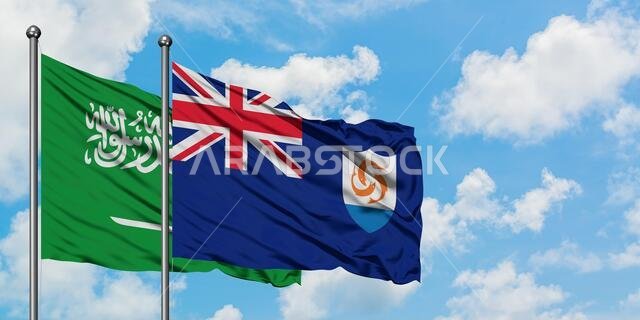 Saudi Arabia and Anguilla flag waving in the wind against white cloudy blue sky together. Diplomacy concept, international relations.