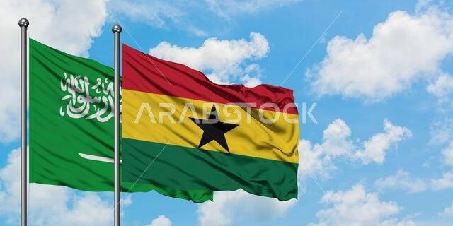 Saudi Arabia and Ghana flag waving in the wind against white cloudy blue sky together. Diplomacy concept, international relations.