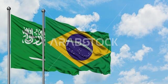 Saudi Arabia and Brazil flag waving in the wind against white cloudy blue sky together. Diplomacy concept, international relations.