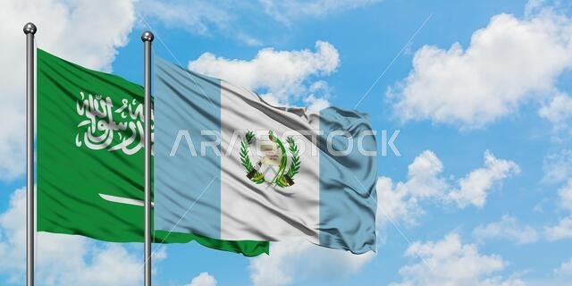 Saudi Arabia and Guatemala flag waving in the wind against white cloudy blue sky together. Diplomacy concept, international relations.