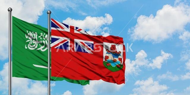 Saudi Arabia and Bermuda flag waving in the wind against white cloudy blue sky together. Diplomacy concept, international relations.