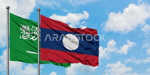 Saudi Arabia and Laos flag waving in the wind against white cloudy blue sky together. Diplomacy concept, international relations.