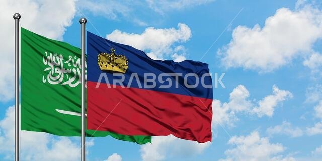 Saudi Arabia and Liechtenstein flag waving in the wind against white cloudy blue sky together. Diplomacy concept, international relations.