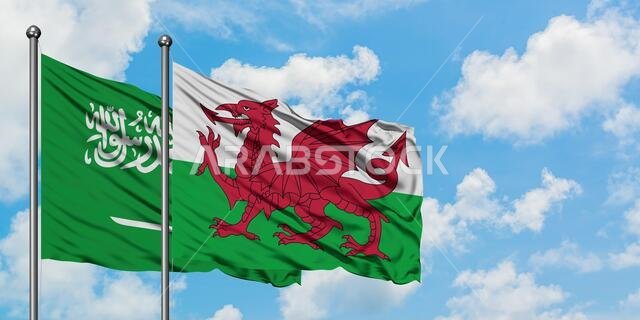 Saudi Arabia and Wales flag waving in the wind against white cloudy blue sky together. Diplomacy concept, international relations.