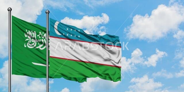 Saudi Arabia and Uzbekistan flag waving in the wind against white cloudy blue sky together. Diplomacy concept, international relations.