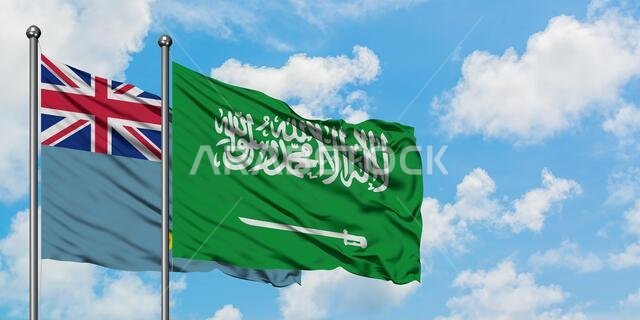 يرفرف علم توفالو وعلم المملكة العربية السعودية معاً في مهب الريح أمام سماء زرقاء صافية تتخللها غيوم بيضاء. مفهوم الدبلوماسية، العلاقات الدولية.