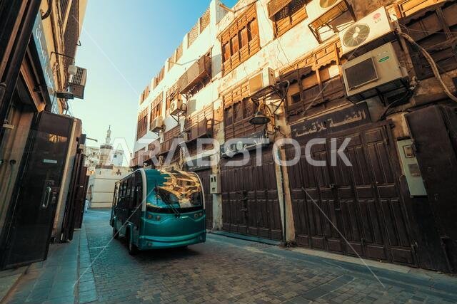 View of a minibus driving through the narrow Suq Al Jami street at the historic district Al Balad in Jeddah, KSA, Saudi Arabia