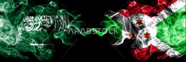 المملكة العربية السعودية ضد بوروندي، أعلام بوروندية ضبابية غامضة موضوعة جنبًا إلى جنب. أعلام دخانية حريرية سميكة الألوان من اللغة العربية وبوروندي.