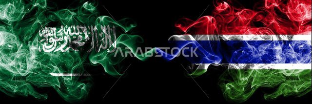 Saudi Arabia Kingdom vs Gambia, Gambian smoky mystic flags placed side by side. Thick colored silky smoke flags of Arabic, Arabian and Gambia, Gambian