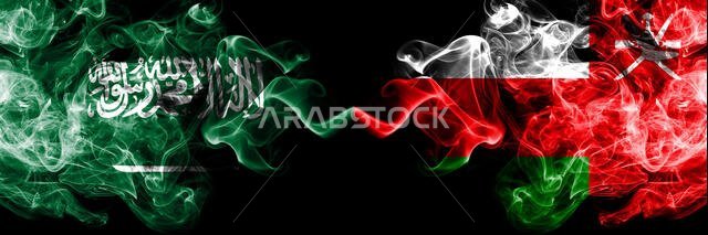 Saudi Arabia Kingdom vs Oman, Omani smoky mystic flags placed side by side. Thick colored silky smoke flags of Arabic, Arabian and Oman, Omani