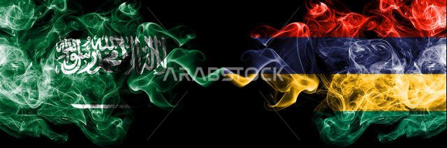 Saudi Arabia Kingdom vs Mauritius, Mauritian smoky mystic flags placed side by side. Thick colored silky smoke flags of Arabic, Arabian and Mauritius,