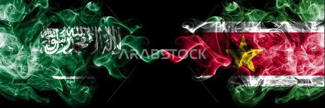 Saudi Arabia Kingdom vs Suriname, Surinamese smoky mystic flags placed side by side. Thick colored silky smoke flags of Arabic, Arabian and Suriname,