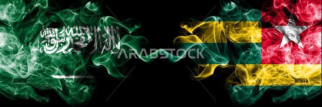 Saudi Arabia Kingdom vs Togo, Togolese smoky mystic flags placed side by side. Thick colored silky smoke flags of Arabic, Arabian and Togo, Togolese