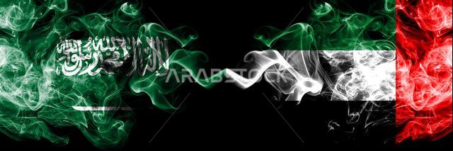 Saudi Arabia Kingdom vs United Arab Emirates, Emirati smoky mystic flags placed side by side. Thick colored silky smoke flags of Arabic, Arabian and U