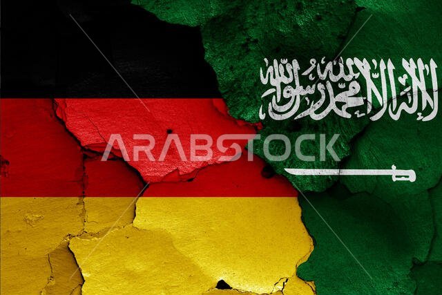 flags of Germany and Saudi Arabia painted on cracked wall