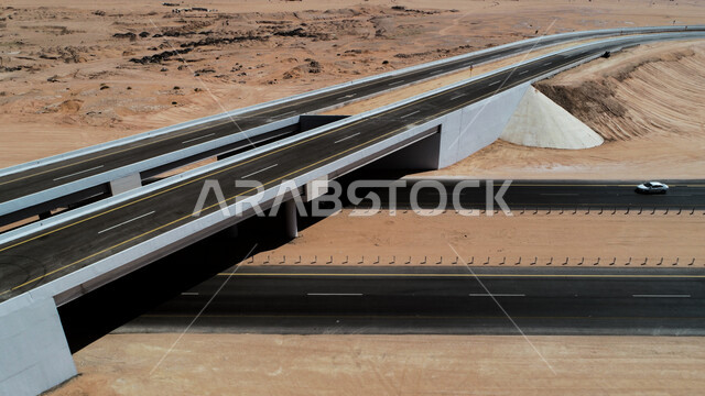 Picture of the highway in the middle of the desert, desert road, asphalt highway between sand dunes, desert nature, sand dunes, desert tourist areas, desert travel road