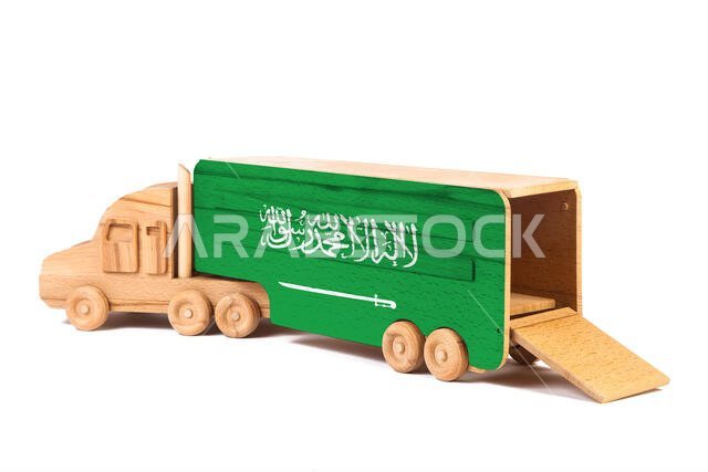 Close-up of a wooden toy truck with a painted national flag Saudi Arabia. The concept of export-import,transportation, national delivery of goods