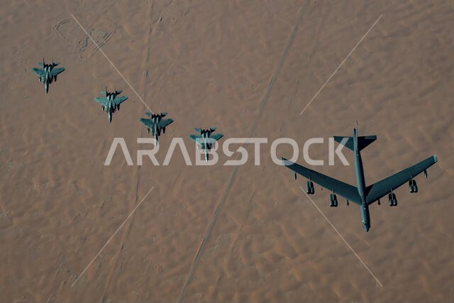 A United States Air Force B-52H Stratofortress, accompanied by four Saudi Arabian F-15C Eagles, conducts a low pass over Prince Sultan Air Base, Saudi Arabia, Nov. 1, 2019. The B-52H, deployed from Barksdale Air Force Base, La., is part of a Bomber Task Force operating out of RAF Fairford, England. The aircraft is a long-range strategic bomber capable of delivering massive amounts of precision weapons against any adversary. The bomber conducted a sortie to the U.S. Central Command area of operat