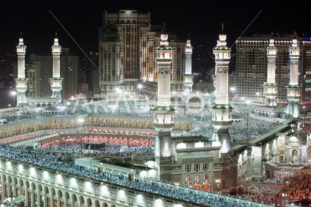 Thousands of Muslims gather around the holy Kaaba, cube at centre, of the Grand Mosque during evening prayer in the holy city of Mecca in Saudi Arabia