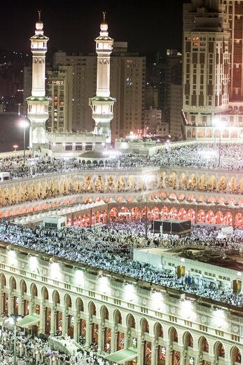 Thousands of Muslims gather around the holy Kaaba, cube at centre, of the Grand Mosque during evening prayer in the holy city of Mecca in Saudi Arabia