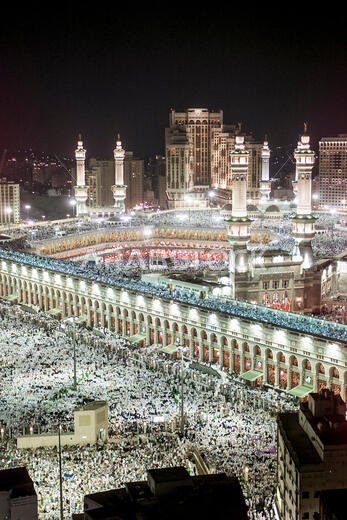 Thousands of Muslims gather around the holy Kaaba, cube at centre, of the Grand Mosque during evening prayer in the holy city of Mecca in Saudi Arabia