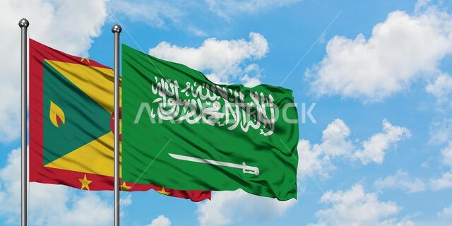 Grenada and Saudi Arabia flag waving in the wind against white cloudy blue sky together. Diplomacy concept, international relations.