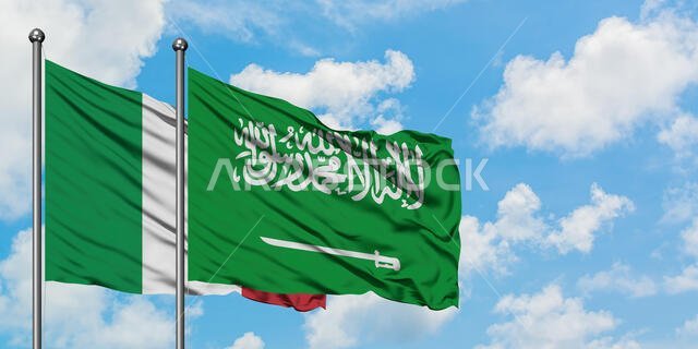 Italy and Saudi Arabia flag waving in the wind against white cloudy blue sky together. Diplomacy concept, international relations.