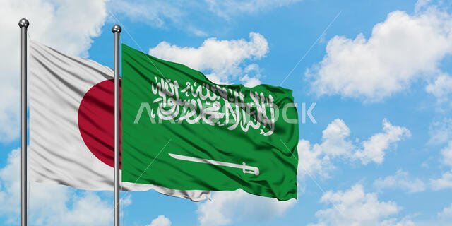 Japan and Saudi Arabia flag waving in the wind against white cloudy blue sky together. Diplomacy concept, international relations.