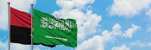 Angola and Saudi Arabia flag waving in the wind against white cloudy blue sky together. Diplomacy concept, international relations.