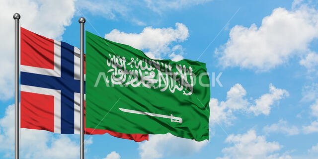 ترفرف أعلام جزر بوفيت والمملكة العربية السعودية في مهب الريح أمام سماء زرقاء ملبدة بالغيوم البيضاء. مفهوم الدبلوماسية، العلاقات الدولية.