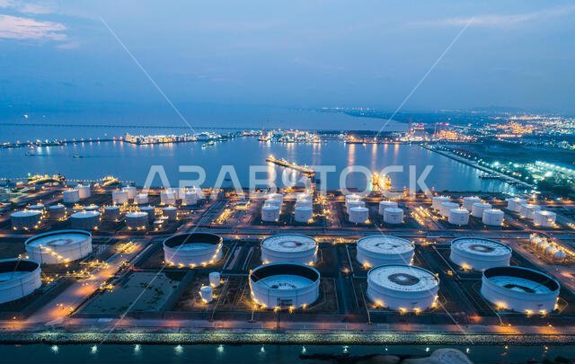 Aerial view oil storage tank with oil refinery factory industrial. Oil refinery plant at night. industry factory concept and transportation.