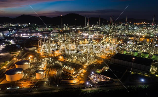 Aerial view oil storage tank with oil refinery factory industrial. Oil refinery plant at night. industry factory concept and transportation.