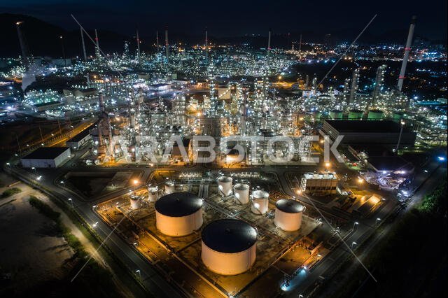 Aerial view oil storage tank with oil refinery factory industrial. Oil refinery plant at night. industry factory concept and transportation.