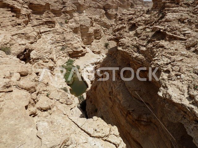 Temporary rainfall ponds in the eroded limestone cavities in the desert near Riyadh