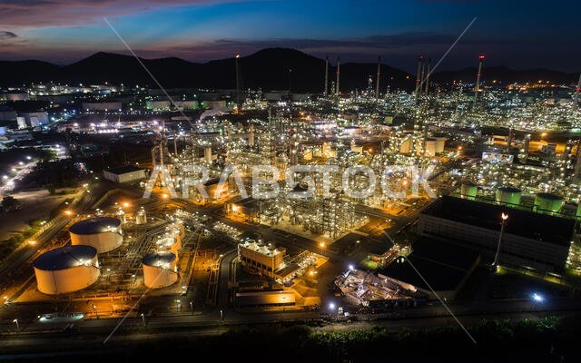 Aerial view oil storage tank with oil refinery factory industrial. Oil refinery plant at night. industry factory concept and transportation.