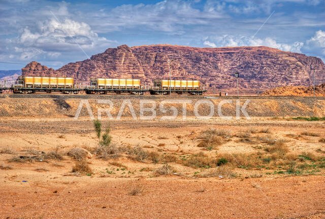 Locomotive train in Wadi Rum desert, Jordan. Railroad through the mountains. Transportation theme.