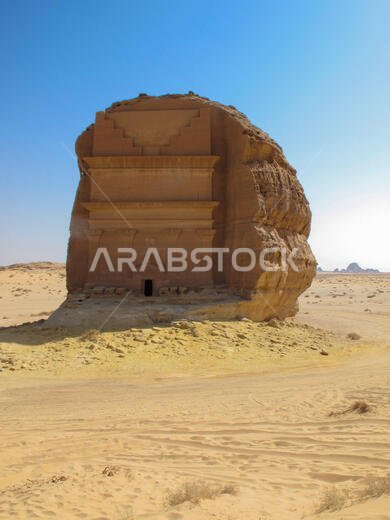 An isolated tomb carved into the rock in Madain Saleh, archaeological site with Nabatean tombs in Saudi Arabia (KSA)