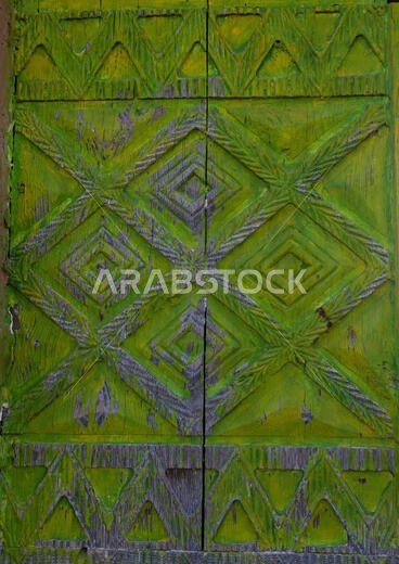 Green wooden door of an old asiri house, Asir province, Khamis Mushait, Saudi Arabia