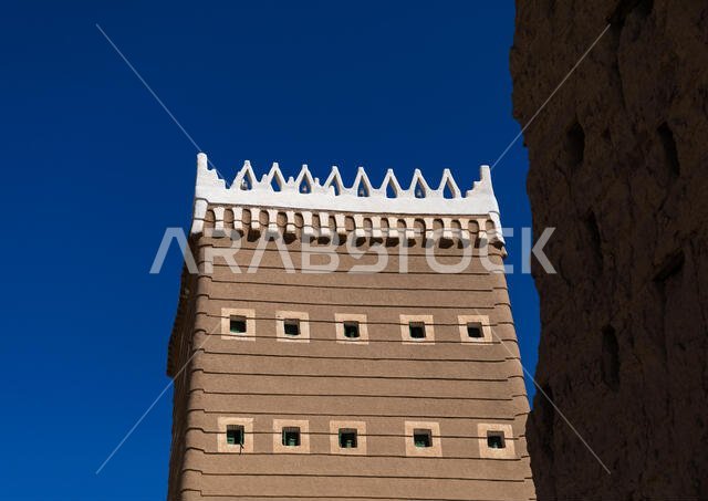 Traditional old mud house against blue sky, Najran Province, Najran, Saudi Arabia