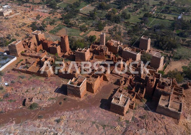 Aerial view of red stone and mud houses with slates in a village, Asir province, Sarat Abidah, Saudi Arabia