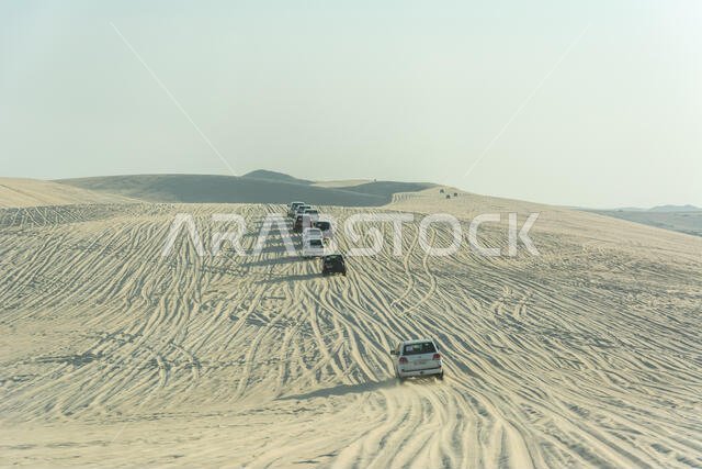 Khor Al Adaid, Qatar - November 5, 2016. 4WD vehicles driving on sand dunes in Khor Al Adaid desert in Qatar.