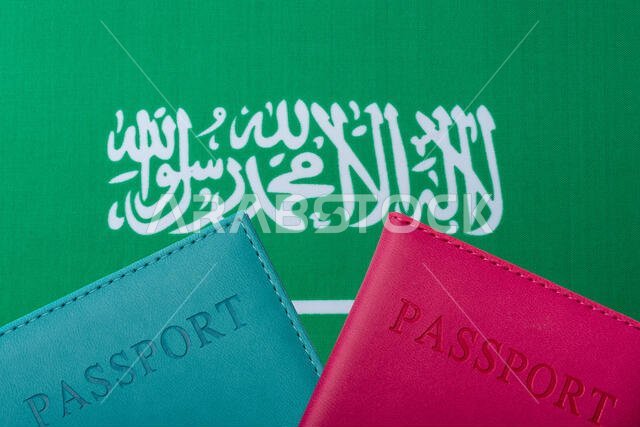 Against the background of the Flag of Saudi Arabia are passports. Travel and tourism concept.