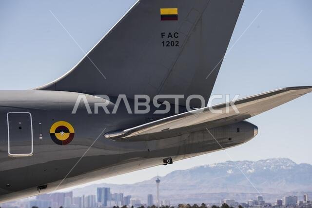 Colombian Air Force Multi-Mission Transport  Tanker Jupiter 767 is parked on the flightline during  Red Flag 19-2 at Nellis Air Force Base, Nev., with  the Las Vegas skyline in the background March 14,  2019. Red Flag 19-2 has a diversity of participants  from around the globe to include Colombia,  Belgium, Netherlands, Saudi Arabia, Singapore,  United Arab Emirates and U.S. joint forces. The  Colombian MMTT Jupiter 767 conducted day and  night refueling missions exclusively with the U.S.  Navy 