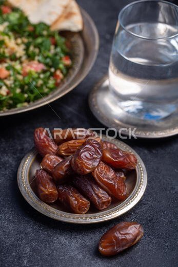 Ramadan dates is traditional food for iftar in islamic world. Dark background
