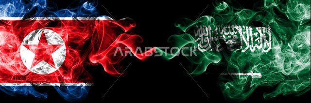 North Korea vs Saudi Arabia, Arabian smoky mystic flags placed side by side. Thick colored silky smoke flags of North Korea and Saudi Arabia, Arabian.