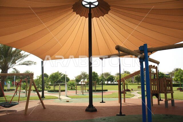 A Modern Design for Kids and Childrens Playing Area with big Tent on Poles to give shade with Trees and Nature