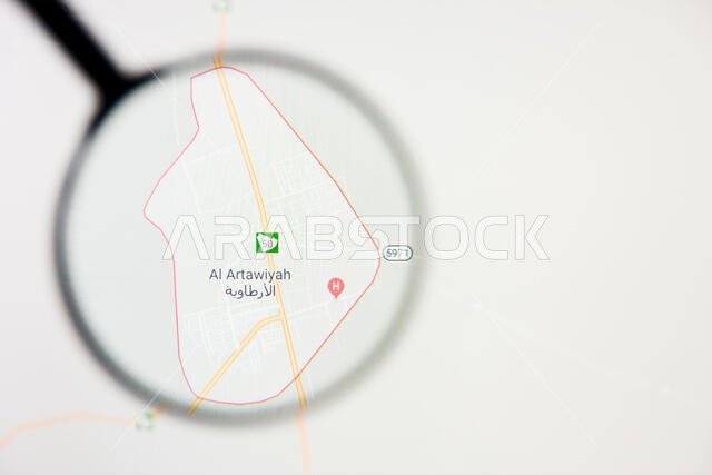مدينة الأرطاوية في المملكة العربية السعودية - تصور توضيحي على الشاشة من خلال عدسة مكبرة