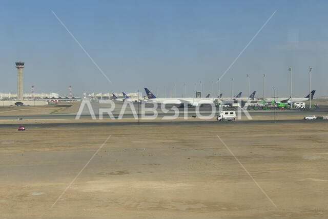 JEDDAH, SAUDI ARABIA - DECEMBER 22, 2018: View over the rollfield of the King Abdulaziz International Airport with SAUDIA Airplanes in the background